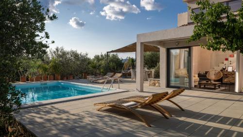 a patio with a pool and chairs and a house at Mai's Villa in Stari Grad