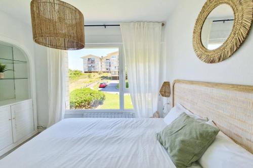 a bedroom with a bed and a large window at ASTONISHING SEA VIEWS - Club & Pool & Parking by ALOHA Bilbao in Sopelana