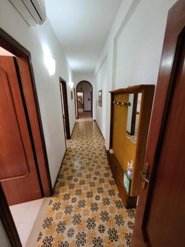 a hallway with a tile floor and a wooden door at Avellino appartamento centralissimo in Avellino