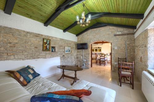 a living room with a couch and a table at Villa Roza in Butkovići