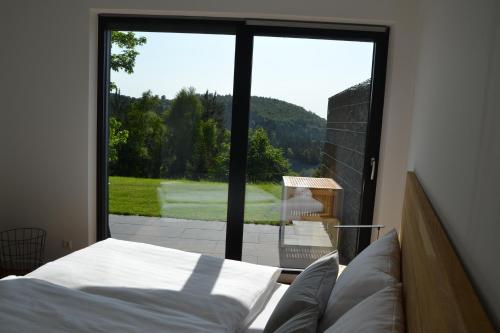 a bedroom with a bed and a large window at Bergweide 36 in Sasbachwalden