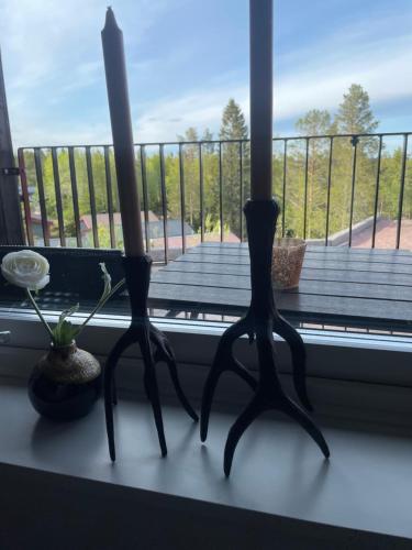 two candles sitting on a window sill with a balcony at Fjällglim 22 Sälfjällstorget in Sälen