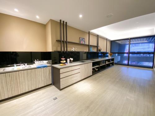 a large kitchen with wooden floors and a large window at Innk in Taichung