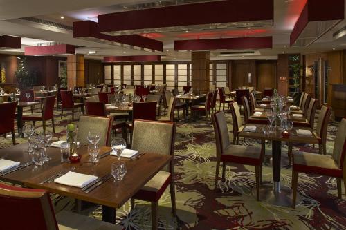a restaurant with tables and chairs with wine glasses at The Bull in Gerrards Cross