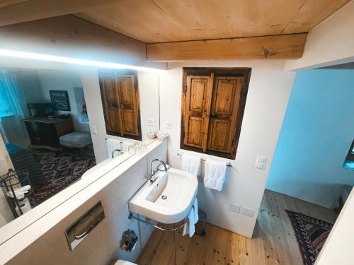 a bathroom with a sink and a mirror at Case di Sotto, House & Breakfast in Locarno
