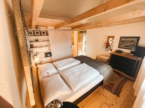 a small bedroom with a bed and a desk at Case di Sotto, House & Breakfast in Locarno