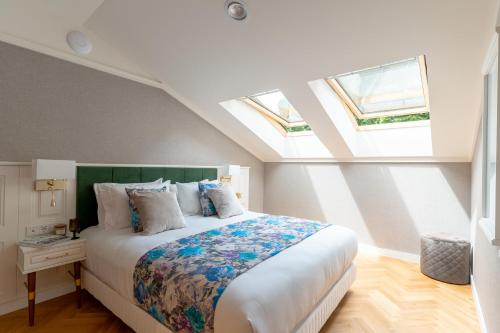 a bedroom with a large bed and skylights at WillaWawel - LoftAffair Collection in Krakow