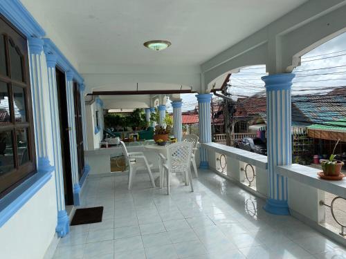 a balcony with a table and chairs on a house at Vacation Home Tambon Karon in Karon Beach