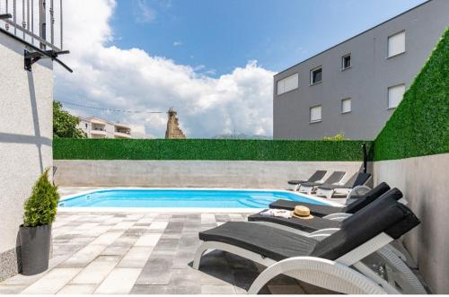 a swimming pool in the backyard of a building at Holiday home Split in Split