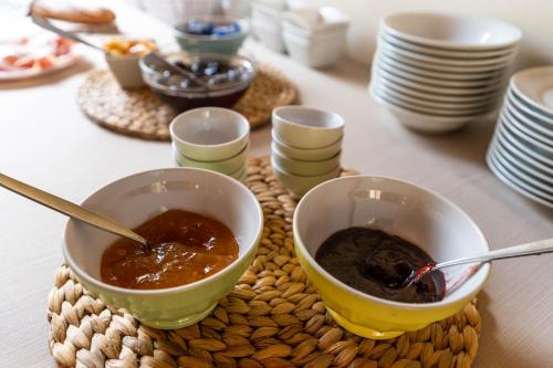 a table with two bowls of soup on a table at Agriturismo Corte Salandini in Ponti Sul Mincio