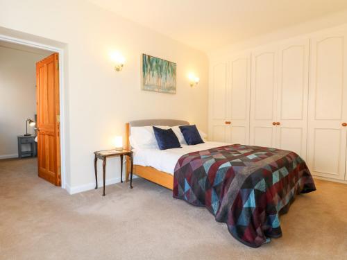 a small bedroom with a bed and a night stand at Elm Tree Cottage in Melton Mowbray