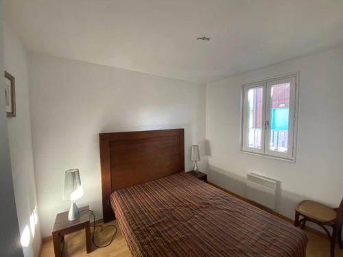 une chambre avec un lit et une fenêtre dans l'établissement residence les rives marines bassin d arcachon, au Teich