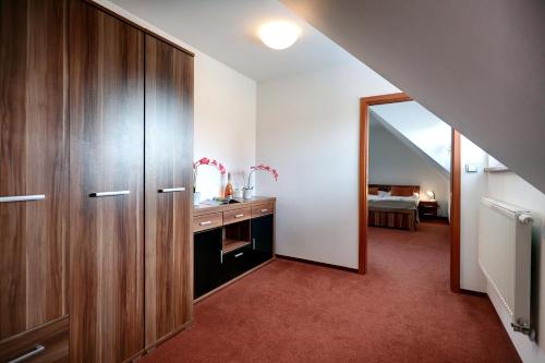 a bathroom with a wooden cabinet and a mirror at Golf&Wellness Resort Alfrédov in Alfrédov