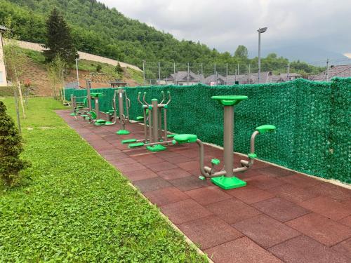a row of exercise machines lined up in the grass at Countryside Resort Sarajevo in Hadžići