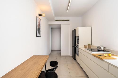 a kitchen with a wooden counter top and a wooden table at Mate TLV PORT - By HOMY in Tel Aviv