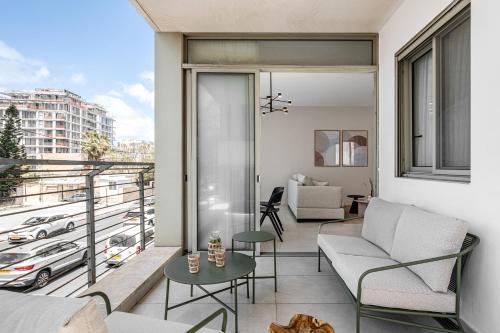 a living room with a balcony with a view of a city at Mate TLV PORT - By HOMY in Tel Aviv