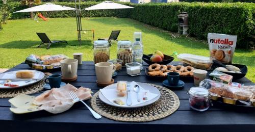 une table bleue avec des assiettes de nourriture et de boissons dans l'établissement Il giardino di Pietro, à Monza