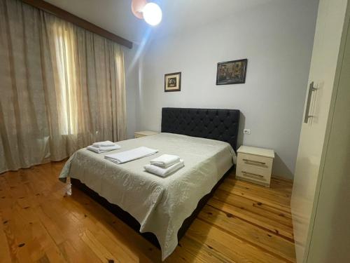 a bedroom with a bed with two towels on it at Leones Villa in Pogradec