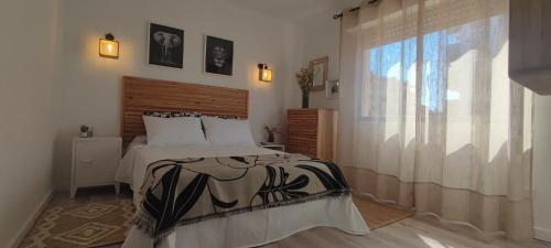 a bedroom with a bed and a large window at Apartamento el Boquerón 3 in Torre del Mar