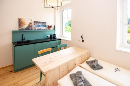 a kitchen with a wooden table and a counter at NaturparkResort GeoApartment in Gams bei Hieflau