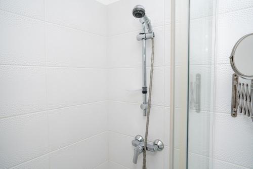 a shower with a shower head in a bathroom at l'itinerance in Mers-les-Bains