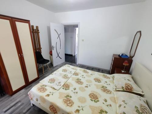 a bedroom with a bed with a floral bedspread at Apartment Serkyovi in Pomorie
