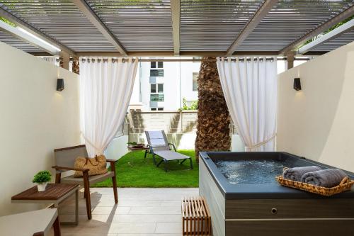 a hot tub in the middle of a patio at Theartemis Palace in Rethymno Town