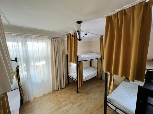 a small room with two bunk beds and a window at Khongor Guest house & Tours in Ulaanbaatar