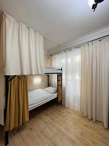 a bedroom with a bunk bed and a window at Khongor Guest house & Tours in Ulaanbaatar