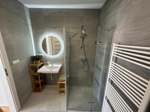 a bathroom with a shower and a sink at GREEN Apartment – City Centre – Main Square in Liptovský Mikuláš