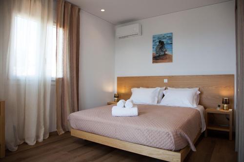 a bedroom with a bed with a white towel on it at Villa Anthodesmi in Dilináta