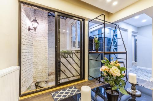 a room with a window and a table with flowers at Centrally Located Flat in Sisli İstanbul in Istanbul