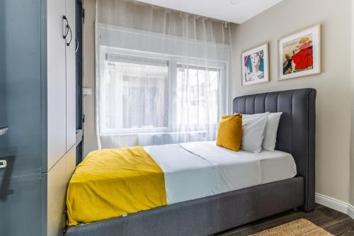 a bedroom with a bed with a yellow blanket at Centrally Located Flat in Sisli İstanbul in Istanbul