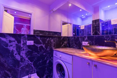 a bathroom with a sink and a washing machine at Royal Verona Relais in Verona