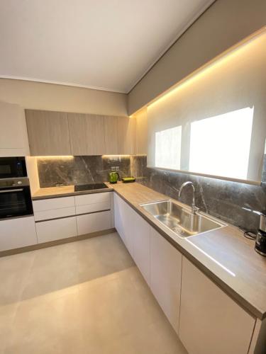 a kitchen with a sink and a window at Porto Rafti Dream Complex & Retreat in Porto Rafti