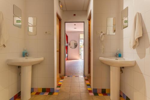 a bathroom with two sinks and a hallway at Mambo Tango in Barcelona