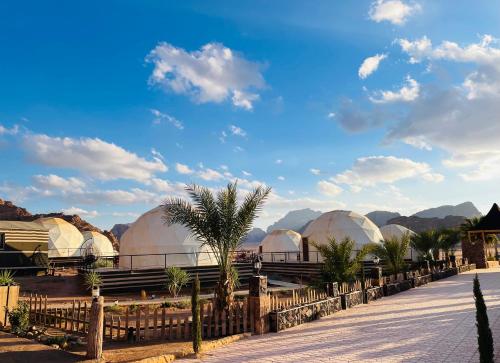 a group of domes with mountains in the background at Hasan Zawaideh Camp in Wadi Rum