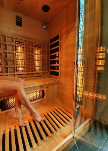 a person sitting on a organ in a sauna at Domandi mountain holiday lodges in Przesieka