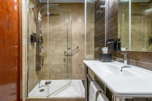 a bathroom with a shower and a sink at Exe Doña Carlota in Ciudad Real