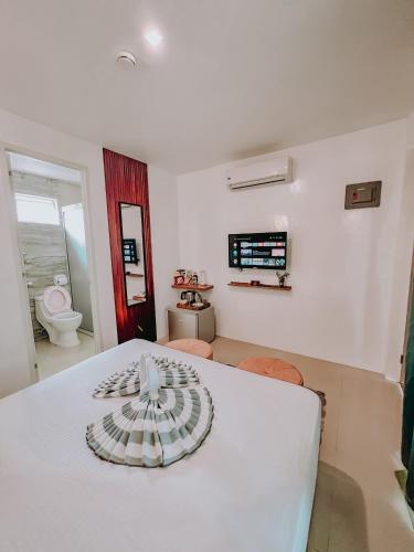 a room with a white table with a bowl on it at A Villas Resort & Restaurant in Zamboanguita