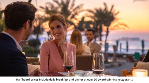 a group of people sitting at a table with wine glasses at Jumeirah Al Naseem Dubai in Dubai