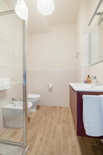 a bathroom with a toilet and a sink and a shower at Appartamento Leonardo in Prato