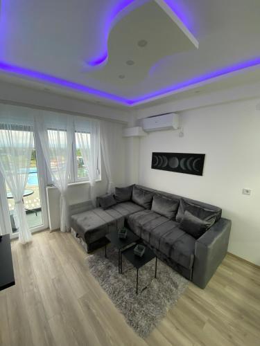 a living room with a couch and a purple ceiling at Aqua Panoramic Apartments in Jagodina