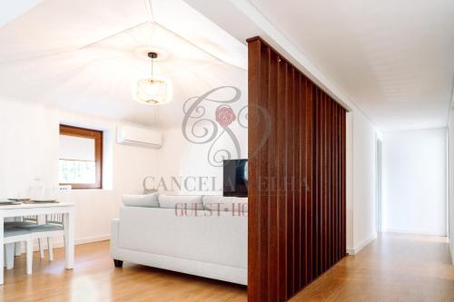 a living room with a couch and a sliding door at Cancela Velha Guest•House in Marco de Canaveses