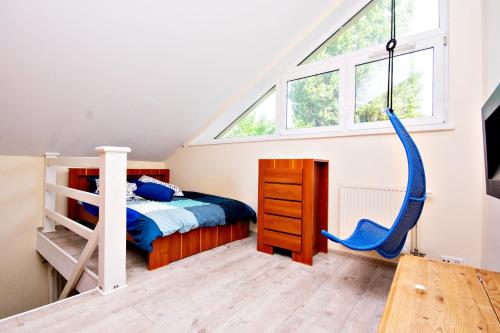 a bedroom with a bunk bed and a swing at Rent40 Sopot Łokietka 47D in Sopot