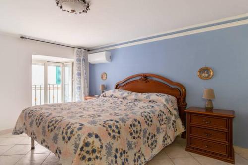 a bedroom with a bed and a dresser and a window at Intero appartamento nel cuore di Cetara in Cetara