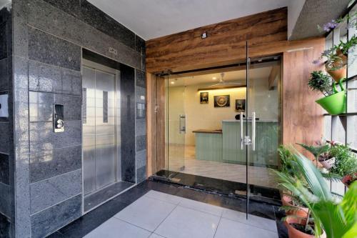 a bathroom with a glass door and a counter at Hotel Royal 24 in Ahmedabad