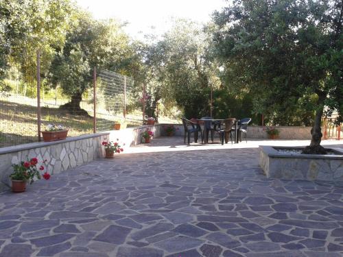 a patio with a tree and a table and chairs at Casa Vacanze Relax in Agropoli