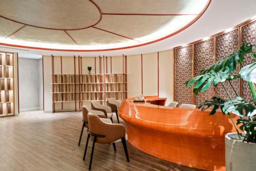 a lobby with a desk and chairs in a building at Angsana Ho Tram in Ho Tram