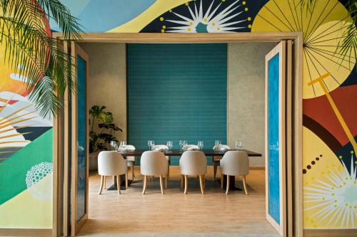 a dining room with a table and chairs at Angsana Ho Tram in Ho Tram